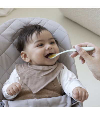 Un bébé qui utilise la cuillères difrax pour manger Un bébé qui utilise la cuillères difrax pour manger